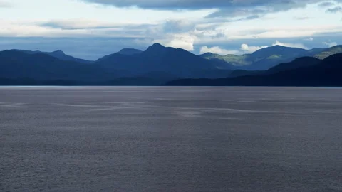 Sun-dappled mountains line the Inside Passage route into Juneau, Alaska Stock Footage 208186493