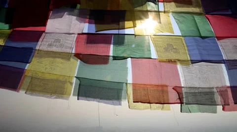Sun darting behind prayer flags Stock Footage 65775272