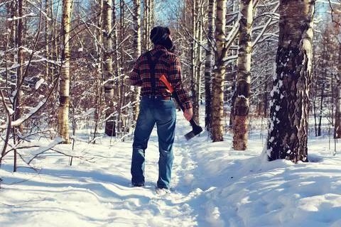 Sun day man with axe in the forest various objects of the winter season in... Stock Photos