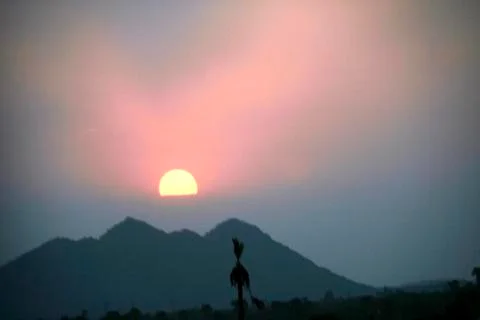 Sun Dip above Peaks Stock Photos