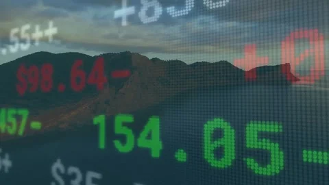 Sun dipping behind ridge ticker overlay floating, displaying market shifts over Video stock 320089257