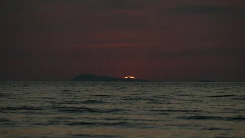 Sun dipping below the horizon over tropical sea Stock Footage 331836101