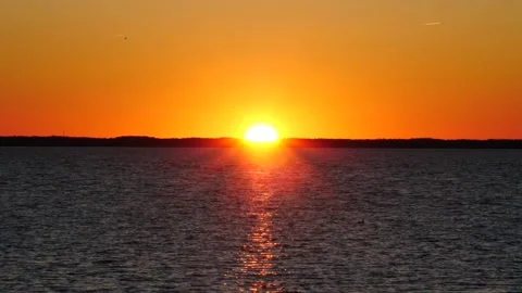 Sun dipping blow the tree line at sunset large yellow sun Stock-Footage 150198231