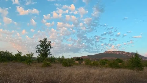 Sun dips behind hills, painting sky in warm hues. Serbia Stock Footage 346250127