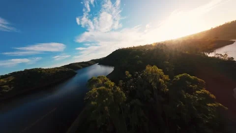 Sun dips low, casting warm light over calm waters Stock Footage 342185529