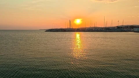 Sun dips low over calm sea waters. Nikiti, Greece 库存影片 338347479