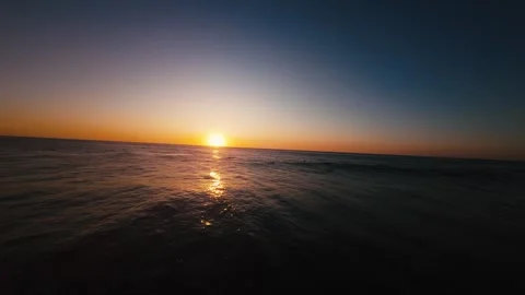Sun dips low, painting ocean in molten gold Stock Footage 339789152