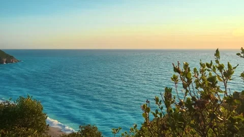 Sun dips low, painting sky in gold and blue. Milos Beach Sunset Greece Stock Footage 344093345