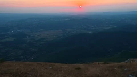 Sun dips low, painting sky in soft pink and orange. Mount Rtanj sunrise Serbia Stock Footage 344685404