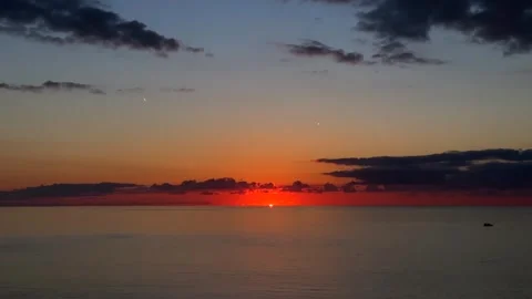 Sun disappearing below horizon, wide view over the sea after sunset Stock Footage 345361900