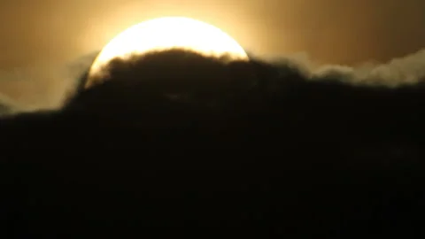 Sun disappearing in black cloud Stock Footage 125338956