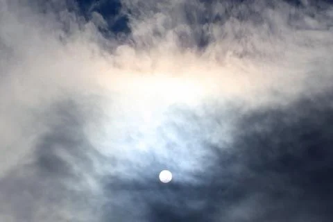 Sun disk at noon through the clouds Stock Photos