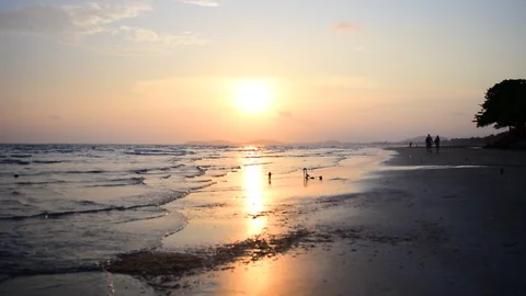 Sun is down by the beach, along with streaky waves of the sea. Stock Footage 87277078