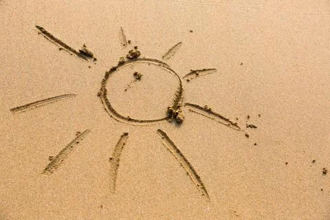 Sun drawn in the sand. Stock Photos