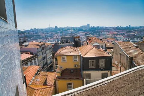 Sun-drenched rooftops cascade across the historic cityscape of Porto. Stock Photos