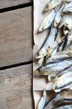 Sun dried fish on the brown paper. Soft focus Stock Photos