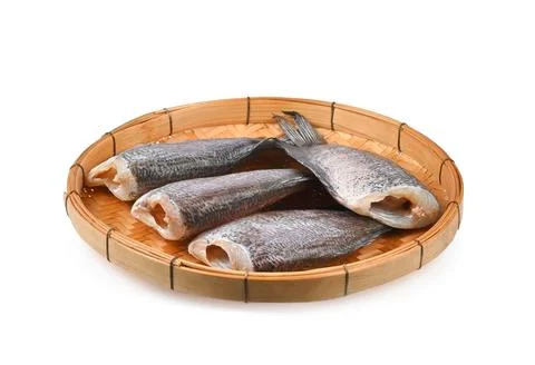 Sun dried fish in threshing basket isolated on white background Stock Photos