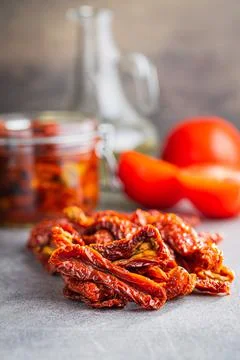 Sun dried tomatoes on kitchen table. Stock Photos
