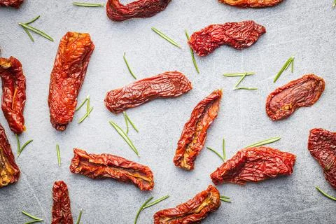 Sun dried tomatoes on kitchen table. Stock Photos