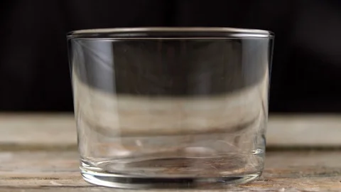 Sun-dried tomatoes in oil fall into a glass in slow motion Stock Footage 113423882