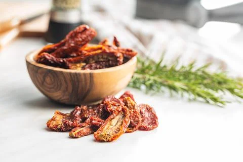 Sun dried tomatoes on white table. Stock Photos