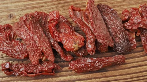 Sun dried tomatoes on a wooden table Stock Footage 170177536