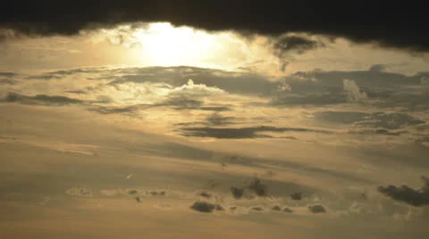 Sun drops down into waves of clouds time lapse HD 1080 version Stock Footage
