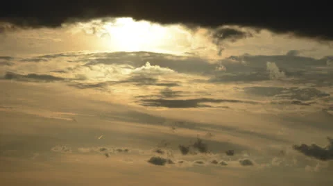 Sun drops down into waves of clouds time lapse 4K version Stock Footage 25066337