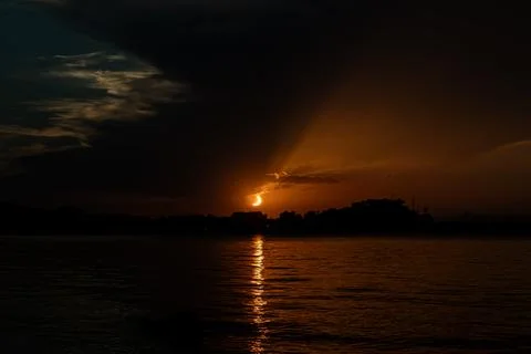 Sun eclipses 2026. Bright crescent sun dips toward Dnia coastline with oran.. Stock Photos
