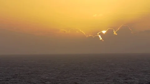 Sun emerging from the clouds and yellow sky Stock Footage 77803910