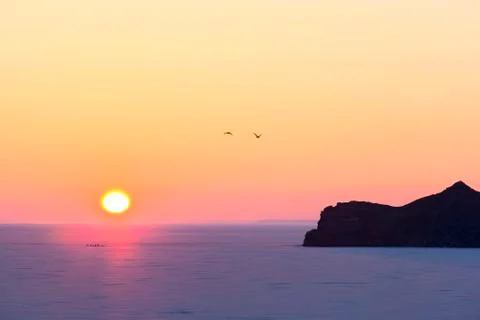 Sun emerging over the horizon Stock Photos