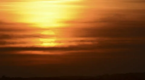 Sun falls behind streamy layers of clouds sunset time lapse HD 1080 Stock Footage 30013159