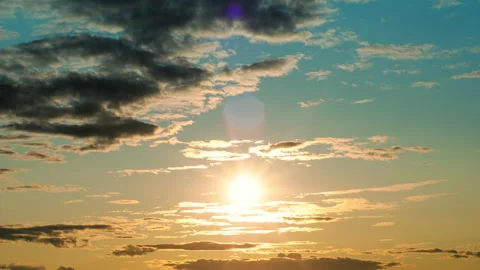 Sun fast moving down through clouds with rays and lens flare. Sunset timelapse Stock Footage 159599714