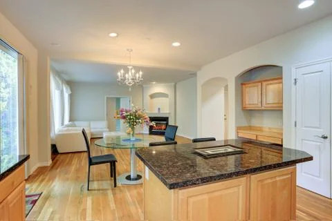 Sun filled open floorplan home interior featuring kitchen island, breakfast n Stock Photos