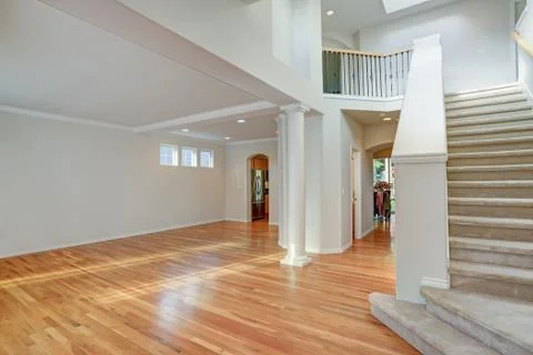 Sun filled open floorplan home interior featuring empty spacious hallway with Stock Photos
