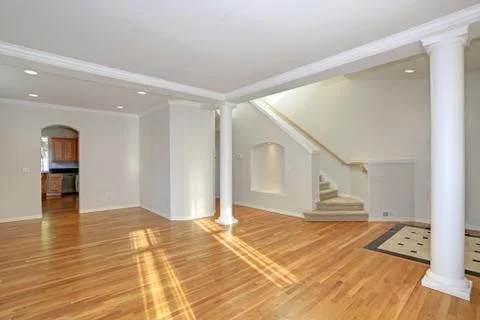 Sun filled open floorplan home interior featuring empty spacious hallway with Stock Photos