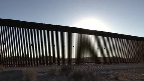 Sun Flare and Border Wall United States U.S. Mexico Boundary Barrier Fence Stock Footage 332244075