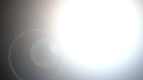 Sun flare lens effect with bokeh circles and light streaks during sunset ci.. Stock Footage 342505386