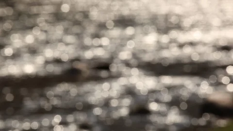 Sun flare reflected on water surface blurred background. Static shot Stock Footage 109508230