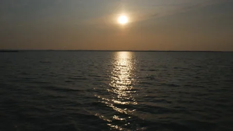 Sun flare sunset view on the high seas. shooting from a moving ship Stock Footage 118129141