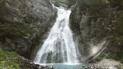 Sun flare on Val Nera Waterfall in Livigno Italian Alps Видео 256240551