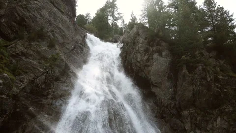 Sun flare of Val Nera Waterfall in Livigno Italian Alps Stockbeeldmateriaal 256243415