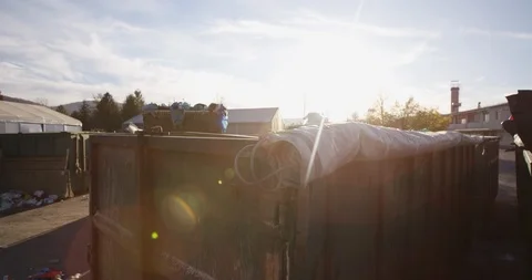 Sun Flared Of Truck Putting Trash Into Garbage Bin Stock Footage 125364916