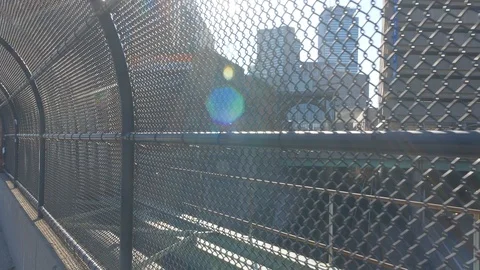 Sun Flares Flickering through Chain Link Fence with Boston Cityscape Video stock 92635116