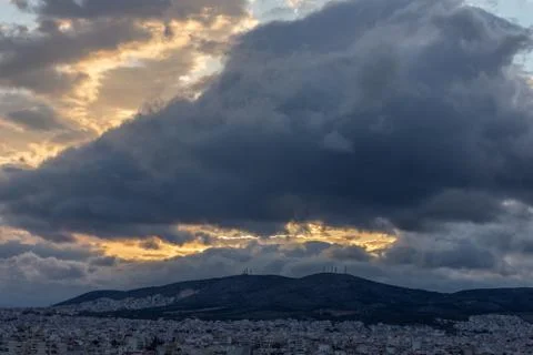 Sun Flares with multi layer clouds in Athens Foto stock