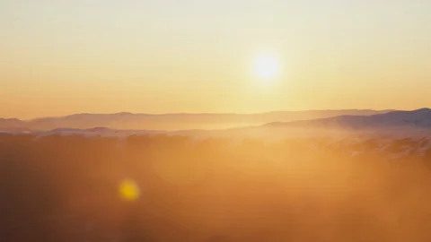 Sun flaring over snow covered mountains in New Zealand Stock Footage 90324633