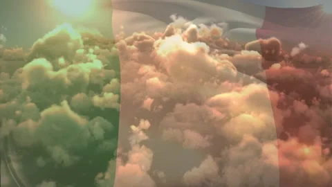 Sun flaring starting thin flag waving over lit clouds aligning stripes through Stock Footage 329703094