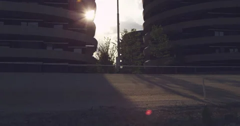 Sun flaring through a futuristic Building Video stock 230459745