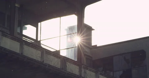 Sun flaring through an old industrial window Stock Footage 230461377