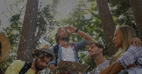 Sun flickering, leader shading eyes and pointing map, group leaning in, overlay Stock Footage 331272503